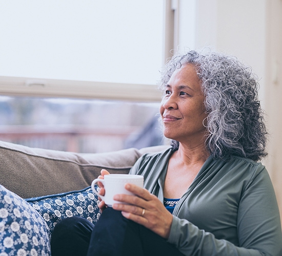 woman sitting enjoying a cup of coffee