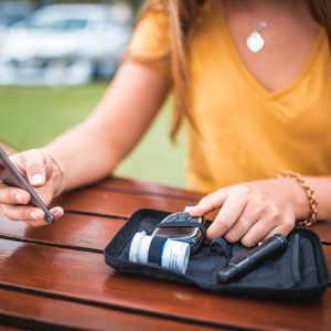 female testing blood pressure outdoors