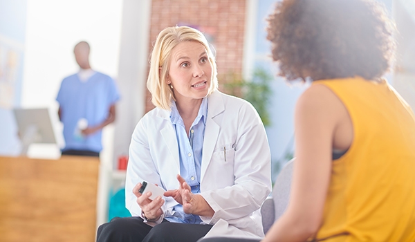 pharmacist conducting health screening with female patient
