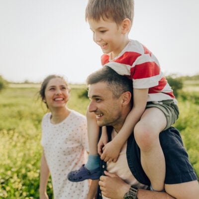 Photo of a little boy and his parents enjoying nature despite seasonal allergies