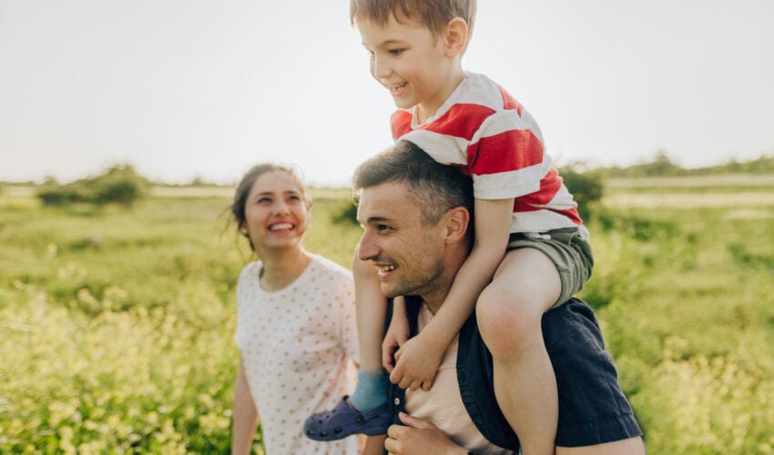 Photo of a little boy and his parents enjoying nature despite seasonal allergies
